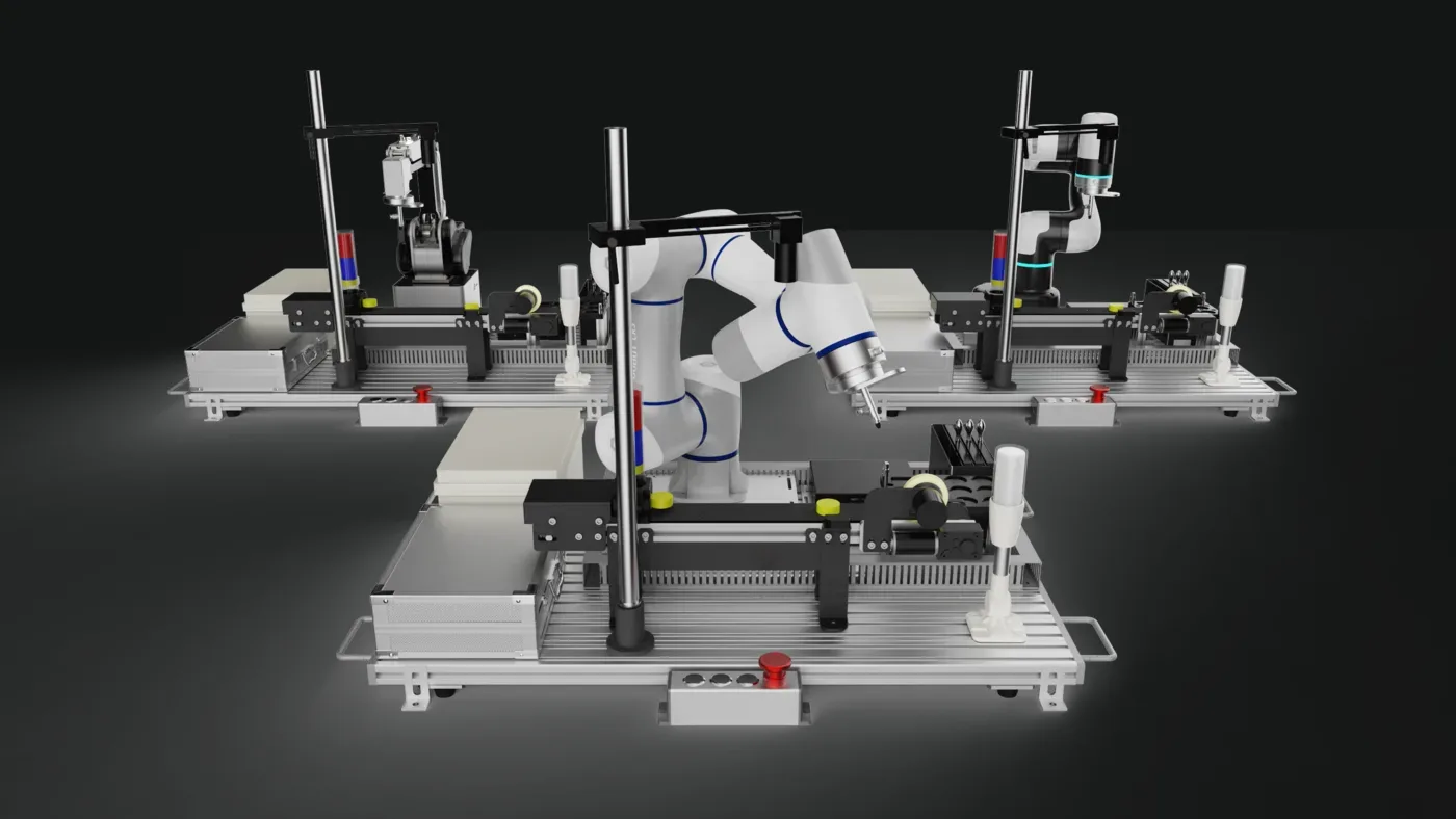 Three benched work cells, each with a robot arm, a signal tower and an emergency stop