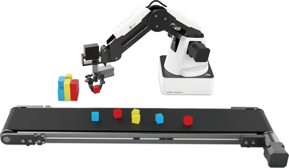 A desktop teaching arm above a short conveyor carrying coloured blocks